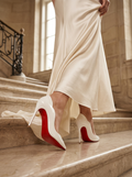 The Signature Stride: Obsidian Pumps with Crimson Soles